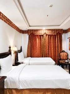 a hotel room with two beds and a window at Viridi Hotels Islamabad in Islamabad +25 photos
