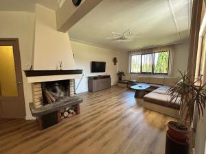a living room with a fireplace and a couch at Къща Петя село Орешак in Troyan