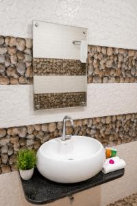 a bathroom with a white sink and a mirror at Hotel Bhakti Rajkot I Hotel in Rajkot I Best Hotel in Rajkot in Rajkot +30 photos