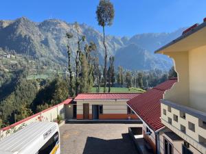 a view of a building with mountains in the background at Tengger Indah Seruni Bromo in Probolinggo