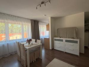 a dining room with a white table and chairs and a window at Stay in Old Town in Võru