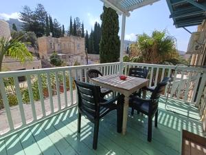 a table and chairs on a deck with a view at Diamond Luxury Apartment - Haifa in Haifa