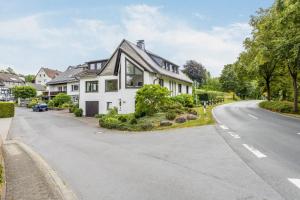 a white house on the side of a road at Fewo Wrede am Sauerland-Radring 1 in Wenholthausen