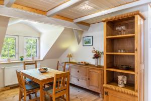 a kitchen with a wooden table and wooden shelves at Ferienwohnung Schwarzmühle 3 in Neuer Anbau +18 photos