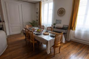 a dining room with a table and chairs at L'échappée Jurassienne - Tout équipé au calme in Saint-Claude