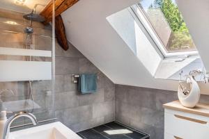 a bathroom with a sink and a skylight at Ferienwohnung Schwarzmühle 3 in Neuer Anbau