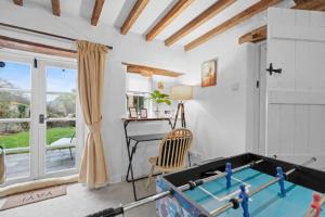 a living room with a pool table and a desk at Traditional Cotswold escape with garden and fireplace in Cheltenham