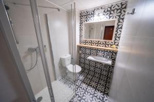 a bathroom with a shower and a toilet and a sink at Penzión Aira in Zvolen +41 photos
