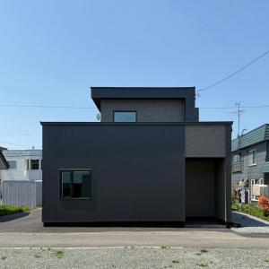 a black house with a black garage at U suzukou in Asahikawa