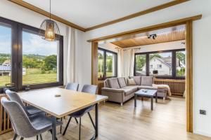 a living room with a table and chairs and a couch at Fewo Wrede am Sauerland-Radring 1 in Wenholthausen