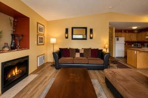 a living room with a couch and a fireplace at Suite Serenity Condo by NW Comfy Cabins in Leavenworth