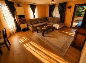 a living room with a couch and a coffee table at Casa Dragomir in Plaiu Şarului