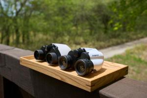 a group of cameras sitting on a wooden board at Suite Villa Panora Yatsugatake in Minamimaki