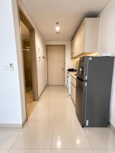 a kitchen with a black refrigerator in a room at Modern studio with a stûnning view at 32 floor in Jakarta