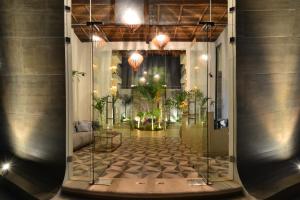 un couloir de verre avec des plantes dans un bâtiment dans l'établissement Elements Tulum Boutique Hotel, à Tulum