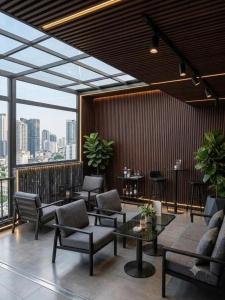 a lobby with chairs and tables and a large window at GRAND SOL LUXURY BOUTIQUE Hotel in Hanoi