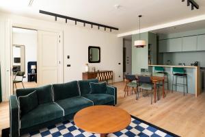a living room with a couch and a table at Faubourg 21 - The Leading Hotels of the World in Brussels