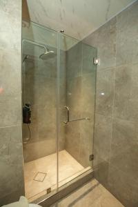 a shower with a glass door in a bathroom at EGI Cebu Resort and Hotel in Maribago +18 photos