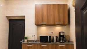 a kitchen with a counter with a microwave and a coffee maker at Optizee Hotel and Suites in Agege +1 photo