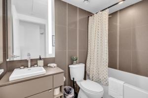 a bathroom with a toilet and a sink and a shower at Toronto Skyline Center Hotel in Toronto