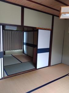 a room with a bunk bed with a door at ゲストハウスぬっく in Tanabe