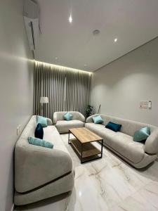 a living room with two couches and a coffee table at خالد للشقق in Ar Rass