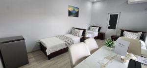 a small room with two beds and a table at Registan Stay in Samarkand