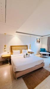 a large bedroom with a large bed and two tables at HOTEL AMORA - Rajnandgaon in Rāj Nāndgaon +91 photos