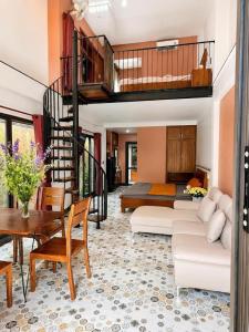 a living room with a loft bed and a couch at 2MINZ Homestay in Thôn An Hòa