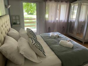 a bed with two towels and pillows on it at LOGEMENT ENTIER Tilleul Suite in Fléac