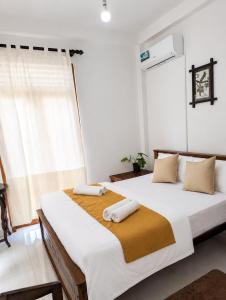 a bedroom with two beds with towels on them at Bliss Stay in Katugastota