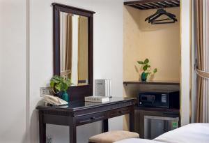 a dressing table in a room with a mirror at Golden Legend Boutique Hotel in Hanoi