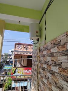a balcony with a light on the side of a building at Harekrishna Nilayam in Vemalwāda