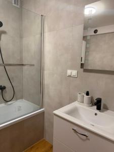 a bathroom with a sink and a shower at Apartament Venis ul Jodłowa in Opole