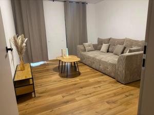 a living room with a couch and a table at Apartament Venis ul Jodłowa in Opole