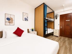 a bedroom with a large white bed and a mirror at Miah Ha Noi Hotel - the best choice in Hà Nội Old Quarter in Hanoi
