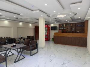 a restaurant with tables and chairs and a soda machine at Double tree hill side resort 2 in Burhānilkantha