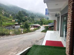 a building with a view of a road and a mountain at Double tree hill side resort 2 in Burhānilkantha
