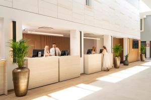 a lobby with people standing at the reception desks at Hotel Garden Istra Plava Laguna in Umag +73 photos