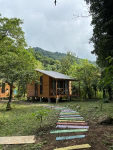 a small house with a pathway leading to it at Babitouli-2 in Niabauri