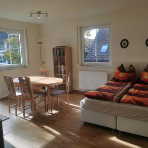 a living room with a couch and a table at FEWO Radebeul Am Waldrand Spittelholz in Radebeul