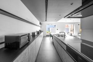 a kitchen with a counter with a microwave on it at S - Vacation STAY 20201 in Asahikawa