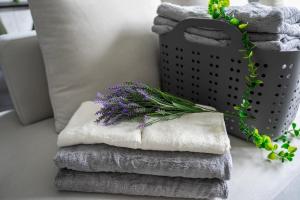 a pile of towels on a table with a bouquet of flowers at S - Vacation STAY 20201 in Asahikawa +95 photos