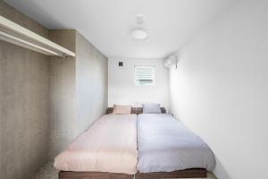 a bedroom with a bed in the corner of a room at S - Vacation STAY 20201 in Asahikawa