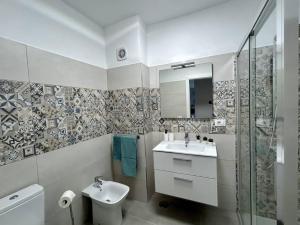 a bathroom with a sink and a toilet and a mirror at Casa Miami Alcalà in Alcalá +14 photos