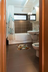 a bathroom with a tub and a toilet and a sink at Sia Mountain Apartment in Predeal +16 photos