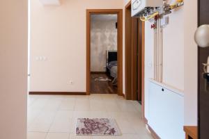 a hallway with a door leading to a living room at Sia Mountain Apartment in Predeal