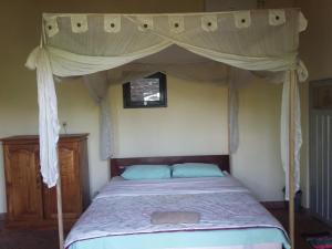 Postel nebo postele na pokoji v ubytování Surya Homestay