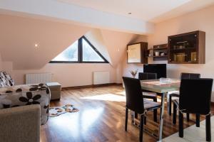 a living room with a table and chairs at Sia Mountain Apartment in Predeal