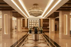 a lobby with a table and a chandelier at Charmillion Gardens Aquapark in Sharm El Sheikh